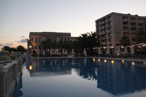 The pool at sunset, with the palace in the distance alongside the main building